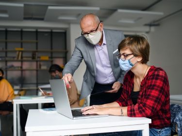  two workers wearing covid style masks